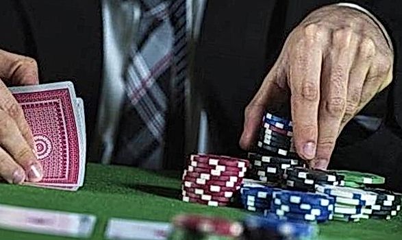 man in suit playing poker